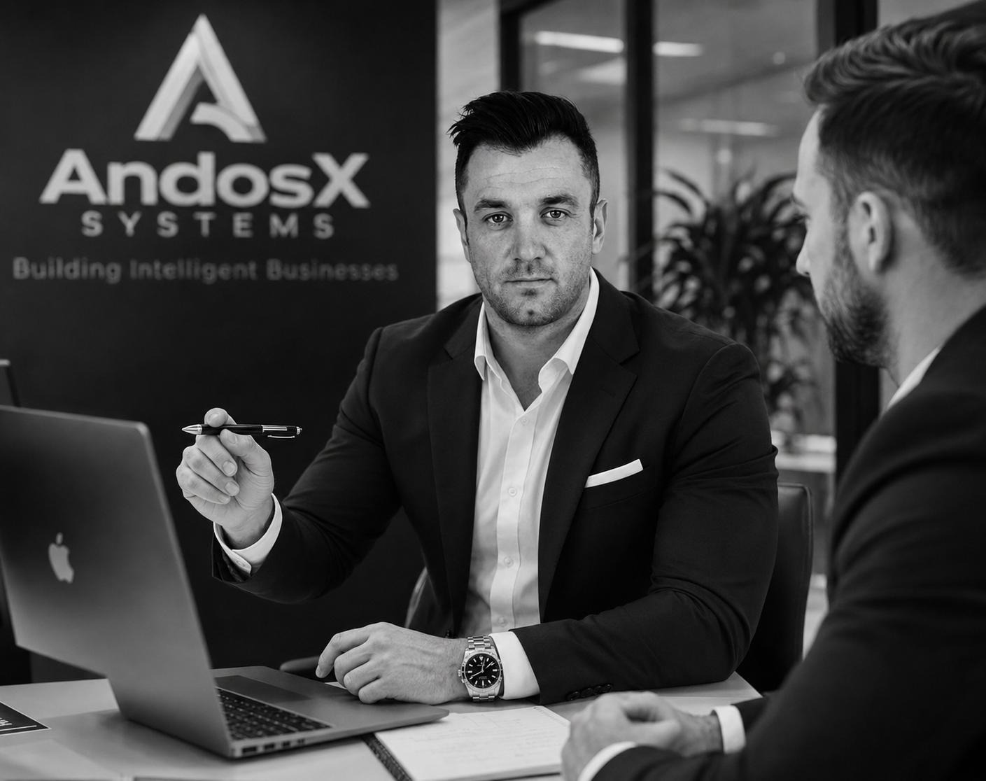 Andy Lister, Founder of AndosX Systems, in conversation with a business owner